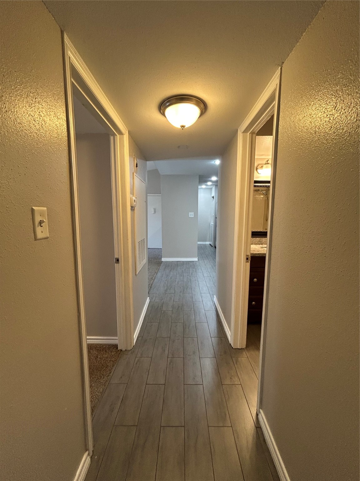 3300 Pebblebrook Drive, Unit 82 Seabrook, TX 77586 - Photo 9 of 13 a view of a hallway with wooden floor