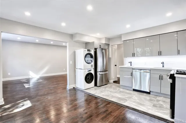 a view of a kitchen with fridge and wooden floor