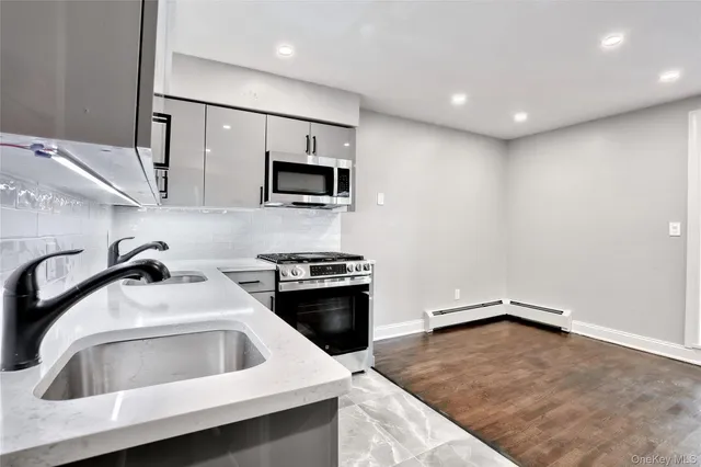 a kitchen that has a sink and a stove