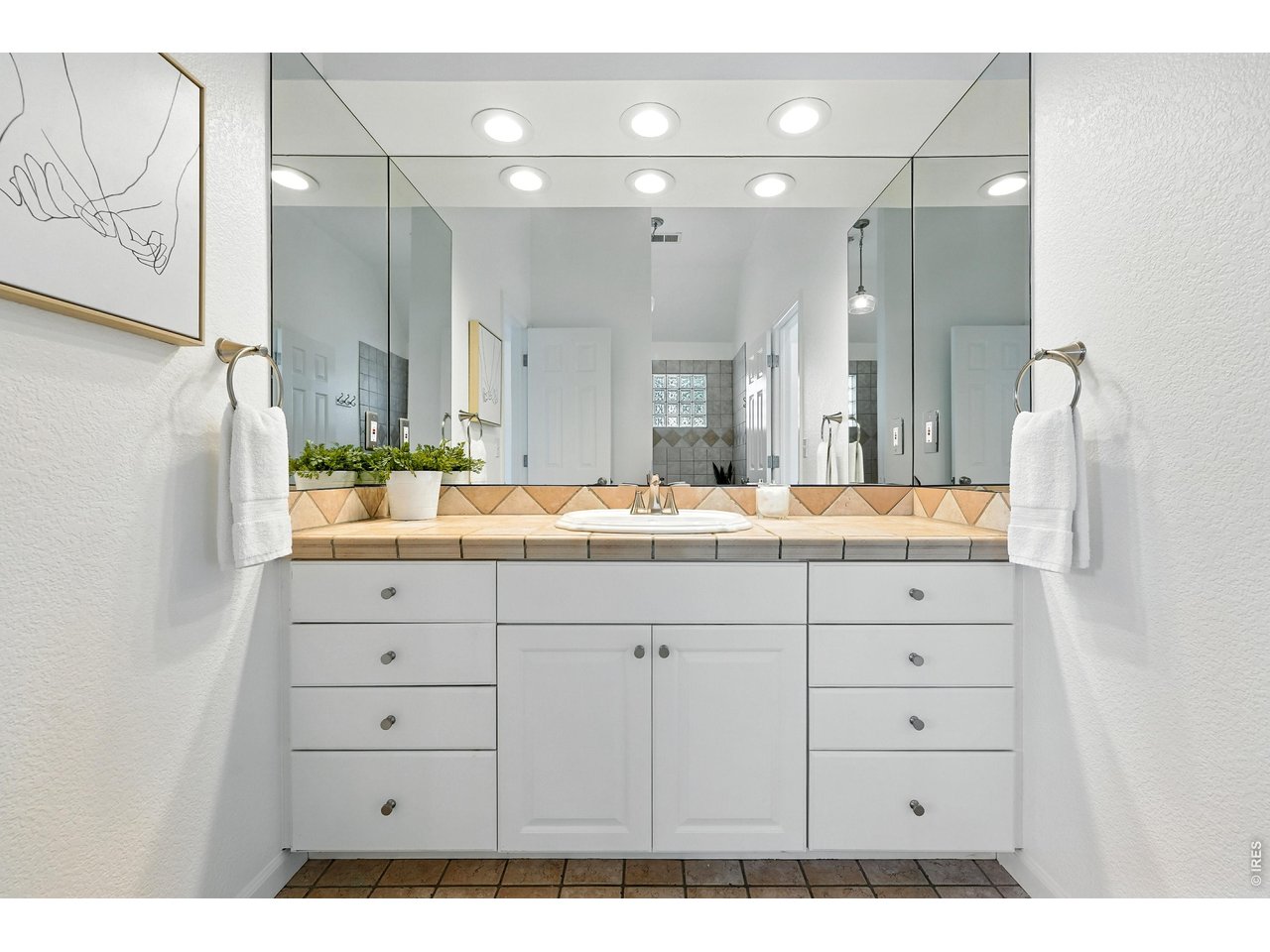 4557 Apple Way Boulder, CO 80301 - Photo 34 of 42 The shared Jack-and-Jill bathroom features a single vanity and a convenient shower-tub combo, designed for simple, functional everyday use.