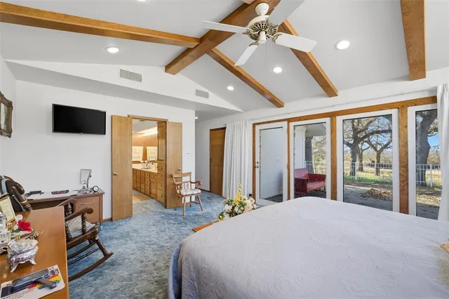 a bedroom with a bed closet and flat tv screen