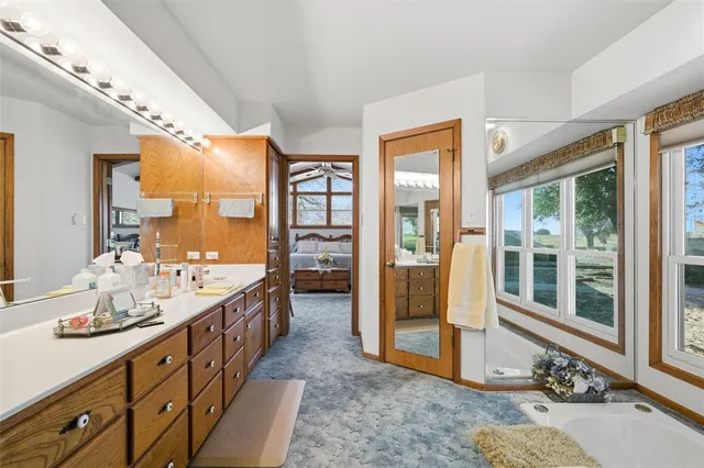 a spacious bathroom with sink shower and mirror