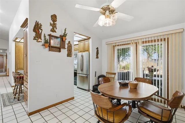 a view of a dining room with furniture and a chandelier