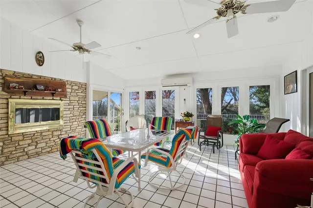 a living room with furniture a chandelier and a fireplace