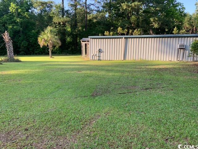 2100 Nesmith Road Nesmith, SC 29580 - Photo 28 of 37 View of grassy yard featuring an outbuilding and view of wooded area