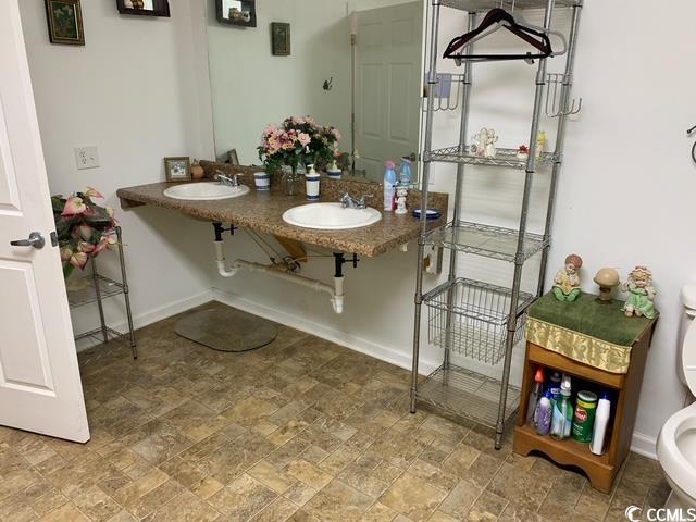 2100 Nesmith Road Nesmith, SC 29580 - Photo 32 of 37 Bathroom featuring stone finish floors, toilet, baseboards, and dual sinks