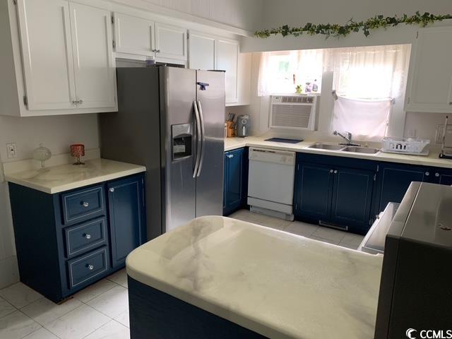 2100 Nesmith Road Nesmith, SC 29580 - Photo 5 of 37 Kitchen featuring blue cabinetry, white dishwasher, a sink, stainless steel fridge, and white cabinetry