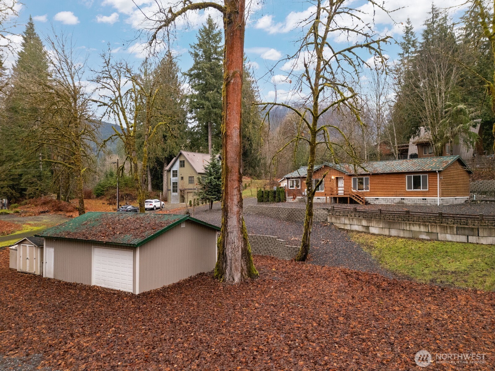 a view of a house with backyard and sitting area