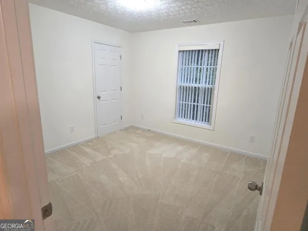 a view of an empty room with windows