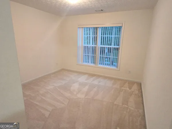 a view of an empty room with windows