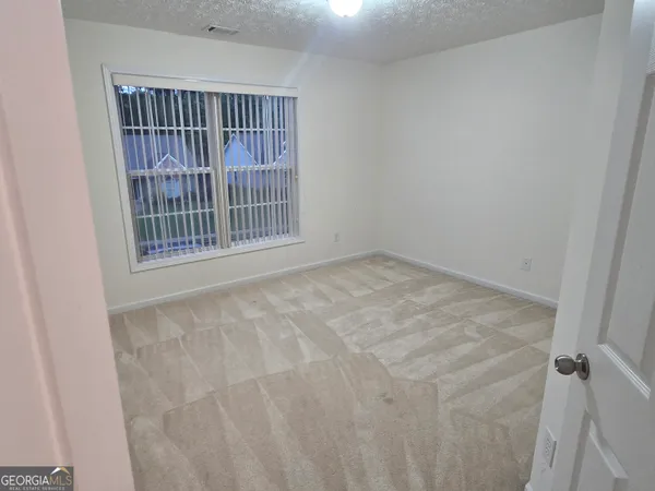 a view of an empty room with staircase