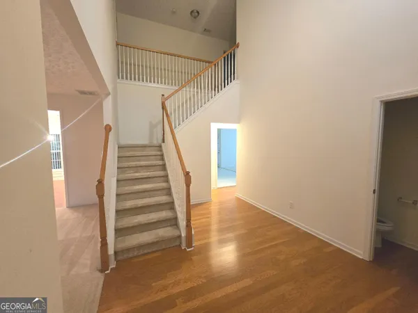 a view of entryway and hall with wooden floor