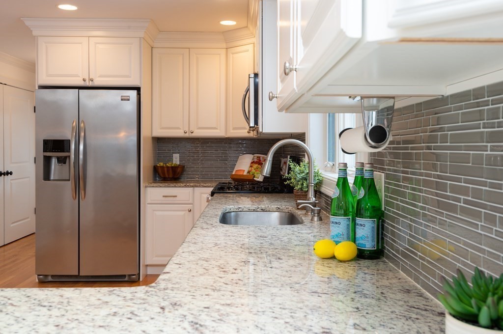 17 Pine Hill Road Lynnfield, MA 01940 - Photo 13 of 42 a kitchen with stainless steel appliances granite countertop a sink a refrigerator a stove and white cabinets