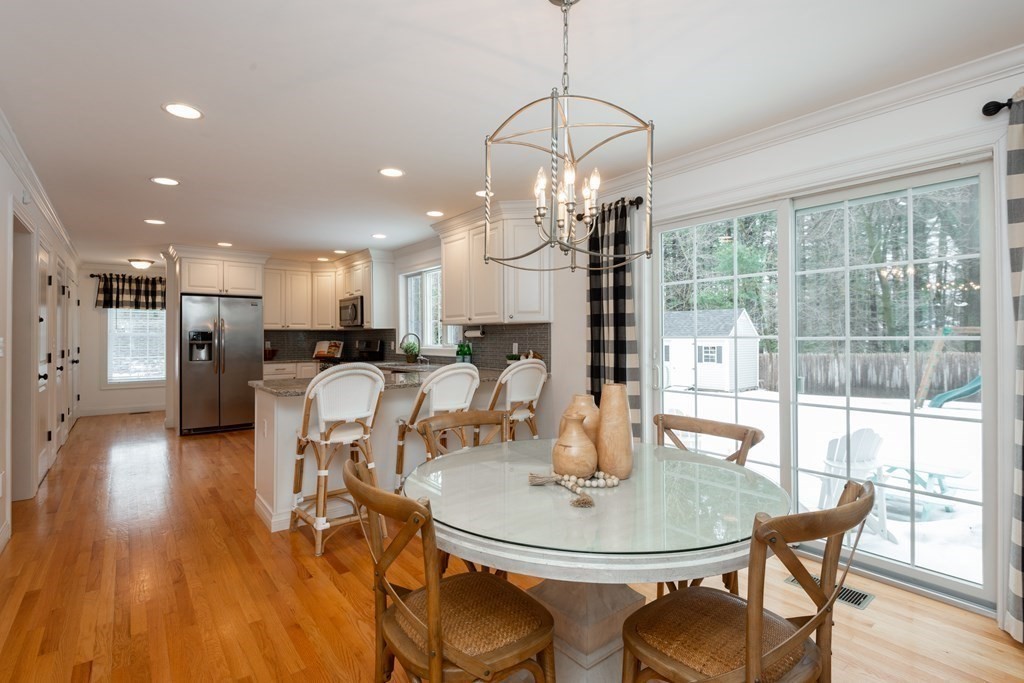 17 Pine Hill Road Lynnfield, MA 01940 - Photo 16 of 42 a dining room with furniture a chandelier and wooden floor