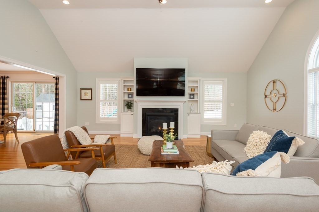 17 Pine Hill Road Lynnfield, MA 01940 - Photo 20 of 42 a living room with furniture a flat screen tv and a fireplace