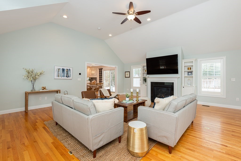 17 Pine Hill Road Lynnfield, MA 01940 - Photo 21 of 42 a living room with furniture a fireplace and a flat screen tv