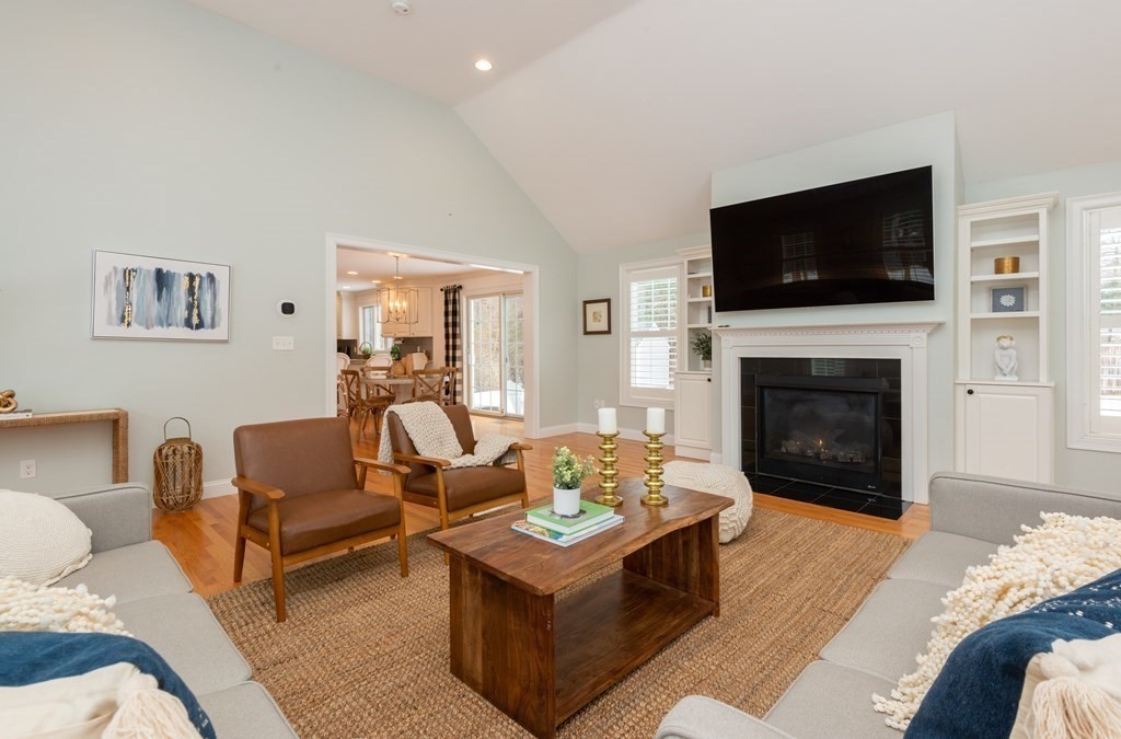 17 Pine Hill Road Lynnfield, MA 01940 - Photo 22 of 42 a living room with furniture a flat screen tv and a fireplace