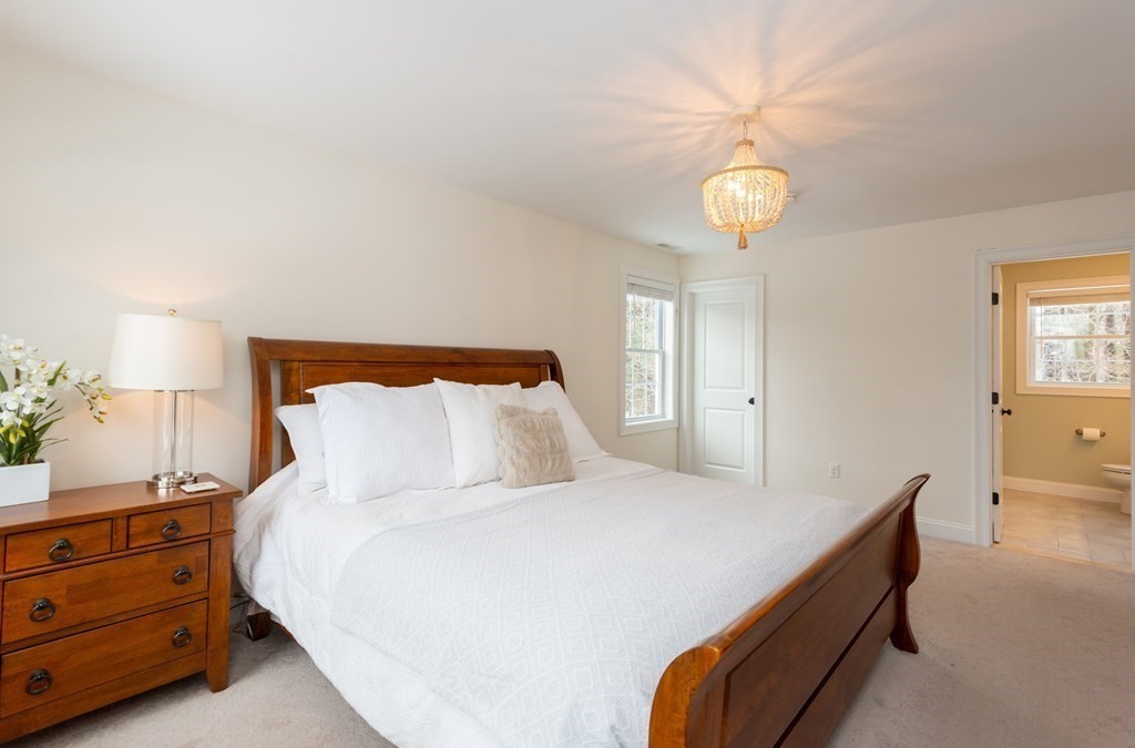 17 Pine Hill Road Lynnfield, MA 01940 - Photo 29 of 42 a bedroom with a bed and a chandelier
