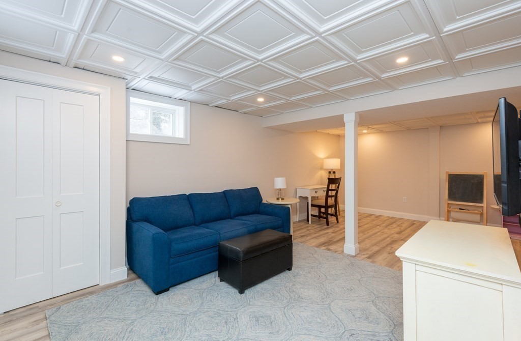 17 Pine Hill Road Lynnfield, MA 01940 - Photo 36 of 42 a living room with furniture and a flat screen tv