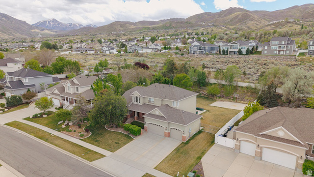 598 Hollow Creek Road Draper, UT 84020 - Photo 4 of 110 Suburban residence featuring a two-story design with an attached three-car garage and a paved driveway