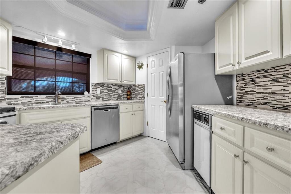 23465 Harbor View Road, Unit 624 Port Charlotte, FL 33980 - Photo 13 of 47 a kitchen with a sink stove and refrigerator