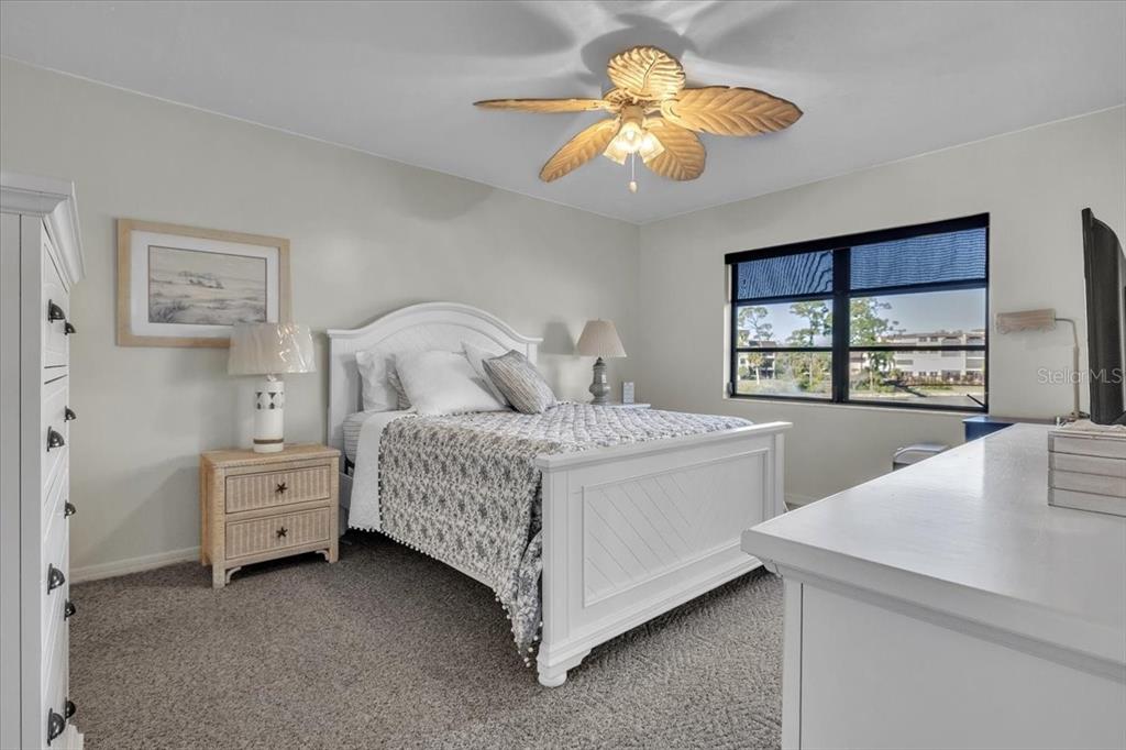 23465 Harbor View Road, Unit 624 Port Charlotte, FL 33980 - Photo 18 of 47 a bedroom with a bed and a chandelier