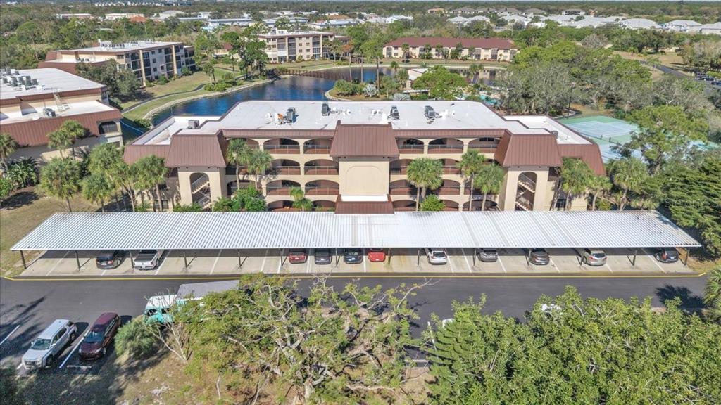 23465 Harbor View Road, Unit 624 Port Charlotte, FL 33980 - Photo 2 of 47 an aerial view of a house with a garden and lake view