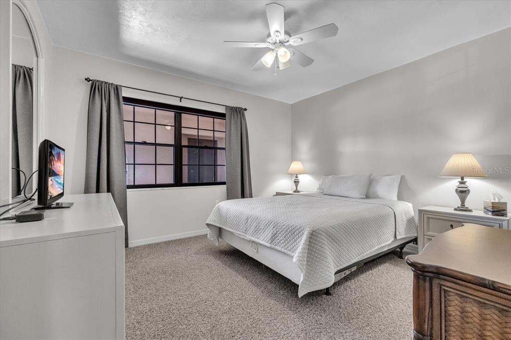 23465 Harbor View Road, Unit 624 Port Charlotte, FL 33980 - Photo 24 of 47 a bedroom with a bed wooden floor and window