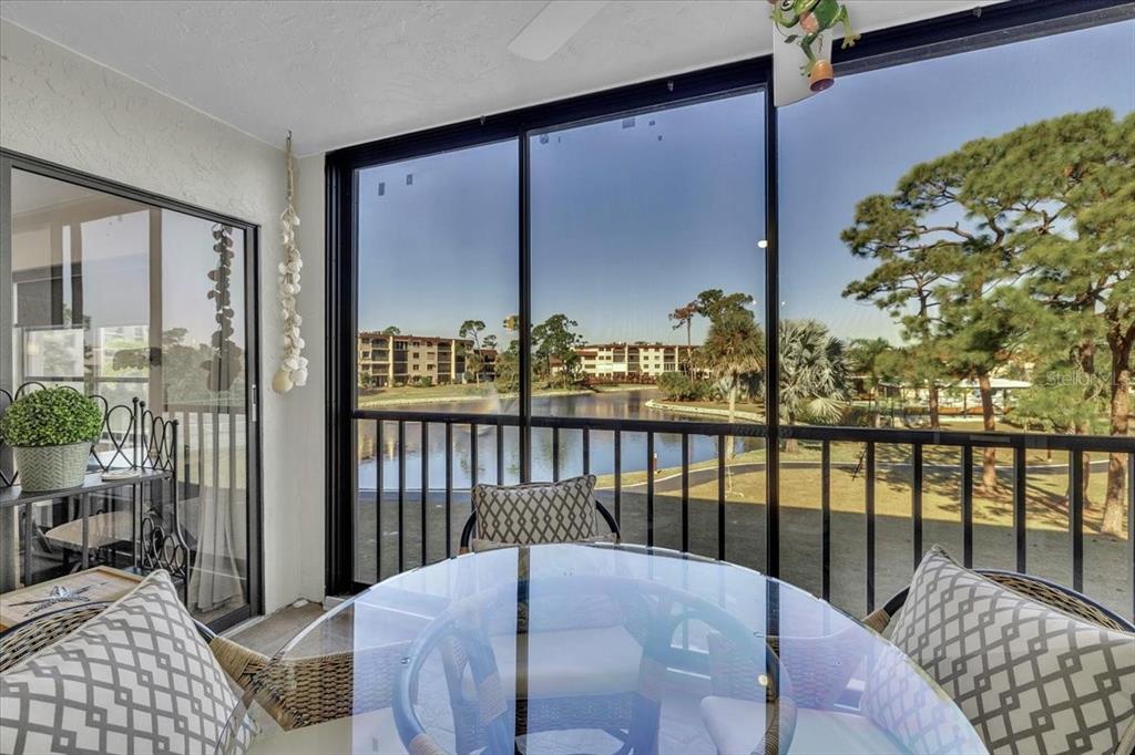 23465 Harbor View Road, Unit 624 Port Charlotte, FL 33980 - Photo 32 of 47 a balcony view with a large window and chairs