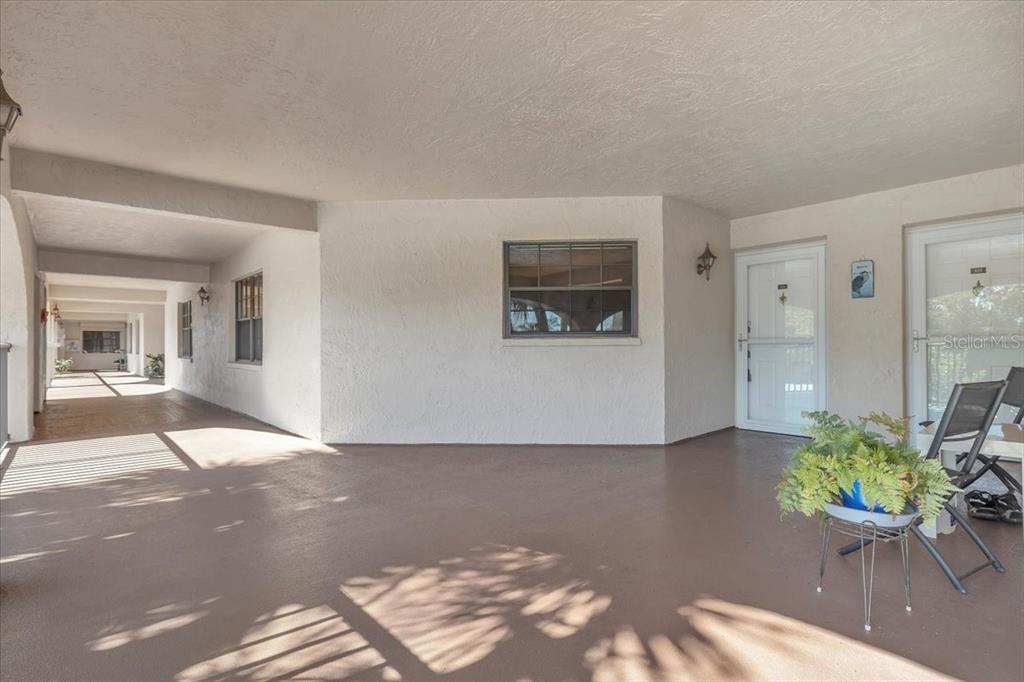 23465 Harbor View Road, Unit 624 Port Charlotte, FL 33980 - Photo 34 of 47 a living room with furniture and a potted plant
