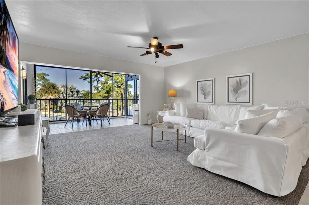 23465 Harbor View Road, Unit 624 Port Charlotte, FL 33980 - Photo 4 of 47 a living room with furniture and a flat screen tv