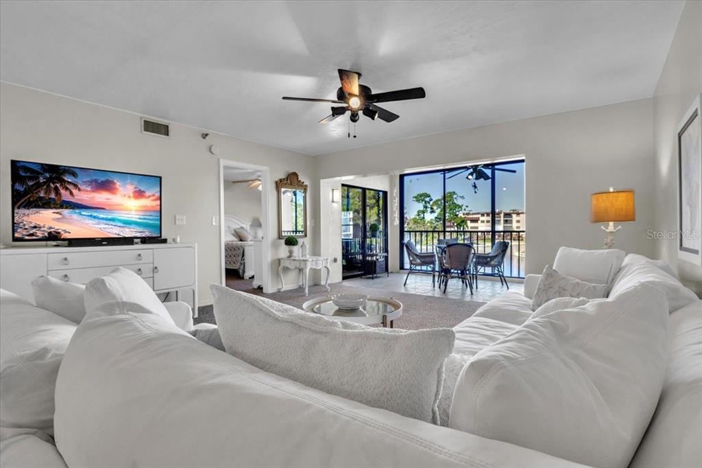 23465 Harbor View Road, Unit 624 Port Charlotte, FL 33980 - Photo 5 of 47 a living room with furniture and a flat screen tv