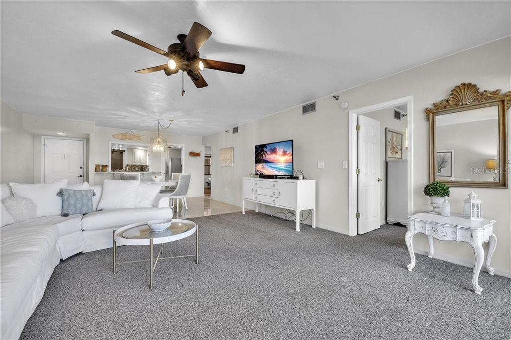 23465 Harbor View Road, Unit 624 Port Charlotte, FL 33980 - Photo 8 of 47 a living room with furniture and a ceiling fan