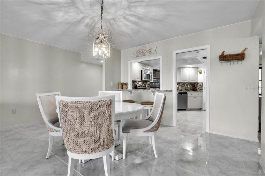 23465 Harbor View Road, Unit 624 Port Charlotte, FL 33980 - Photo 10 of 47 a dining room with furniture and window