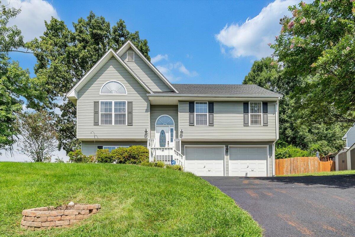 1522 Mountain View Road Vinton, VA 24179 - Photo 1 of 32 a front view of a house with a garden and plants