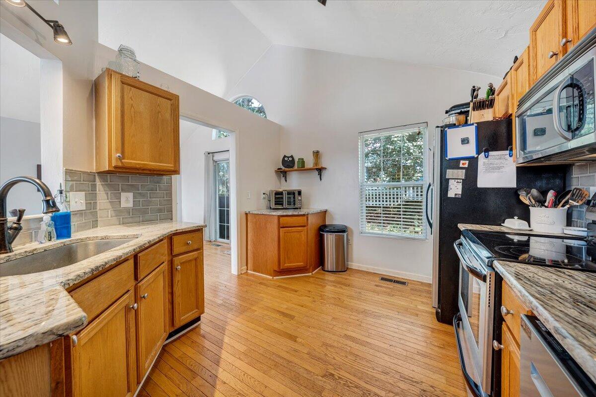 1522 Mountain View Road Vinton, VA 24179 - Photo 11 of 32 a kitchen with stainless steel appliances granite countertop a sink stove and refrigerator