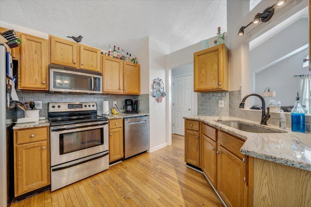 1522 Mountain View Road Vinton, VA 24179 - Photo 13 of 32 a kitchen with stainless steel appliances granite countertop a stove a sink dishwasher and a microwave oven with wooden cabinets