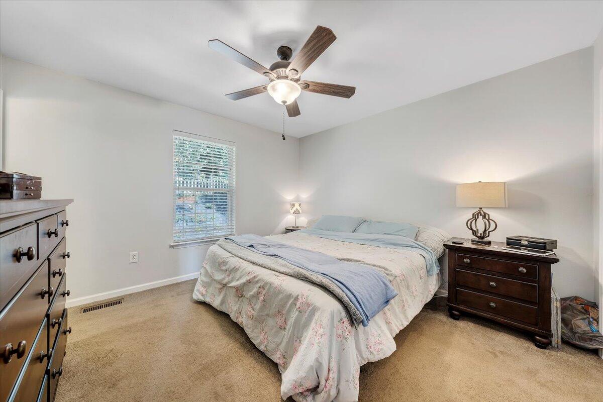 1522 Mountain View Road Vinton, VA 24179 - Photo 15 of 32 a bedroom with a bed and a chandelier