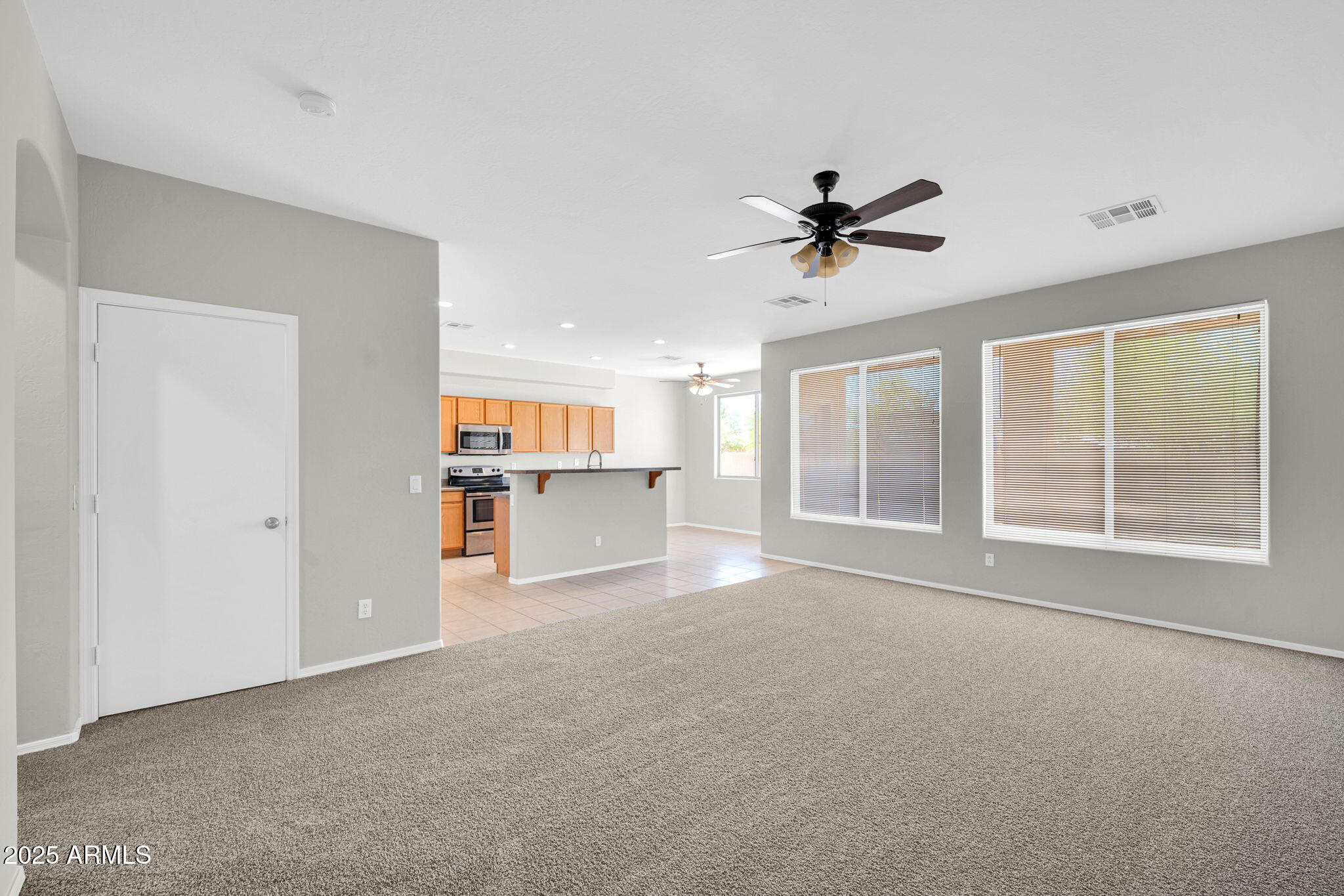 2605 West Darrel Road Phoenix, AZ 85041 - Photo 11 of 33 a view of empty room with a ceiling fan and window
