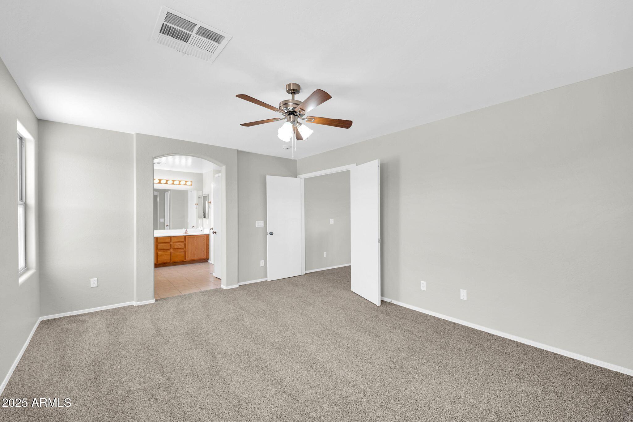2605 West Darrel Road Phoenix, AZ 85041 - Photo 18 of 33 wooden floor in an empty room with a bathroom