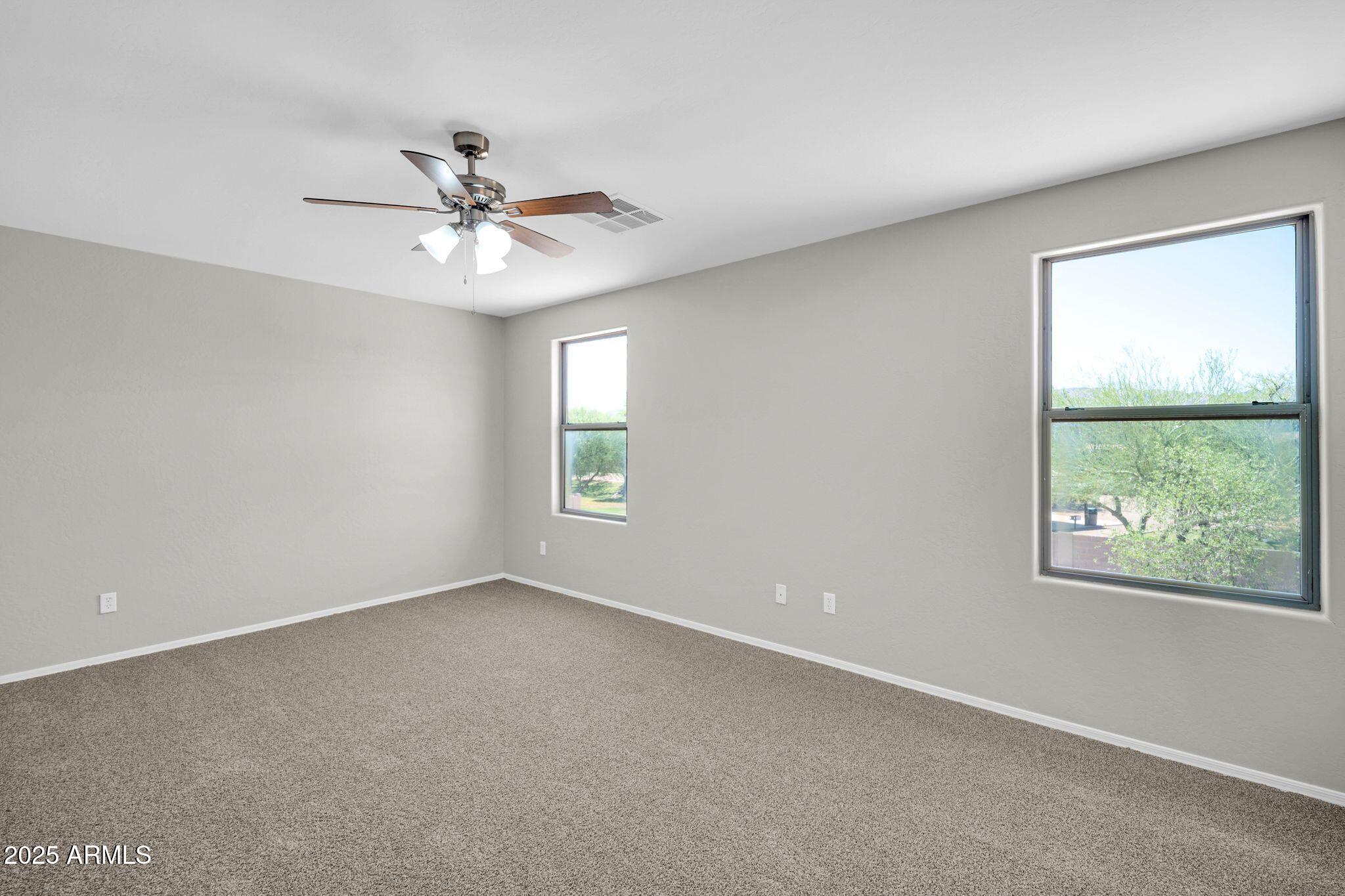 2605 West Darrel Road Phoenix, AZ 85041 - Photo 20 of 33 an empty room with windows and fan