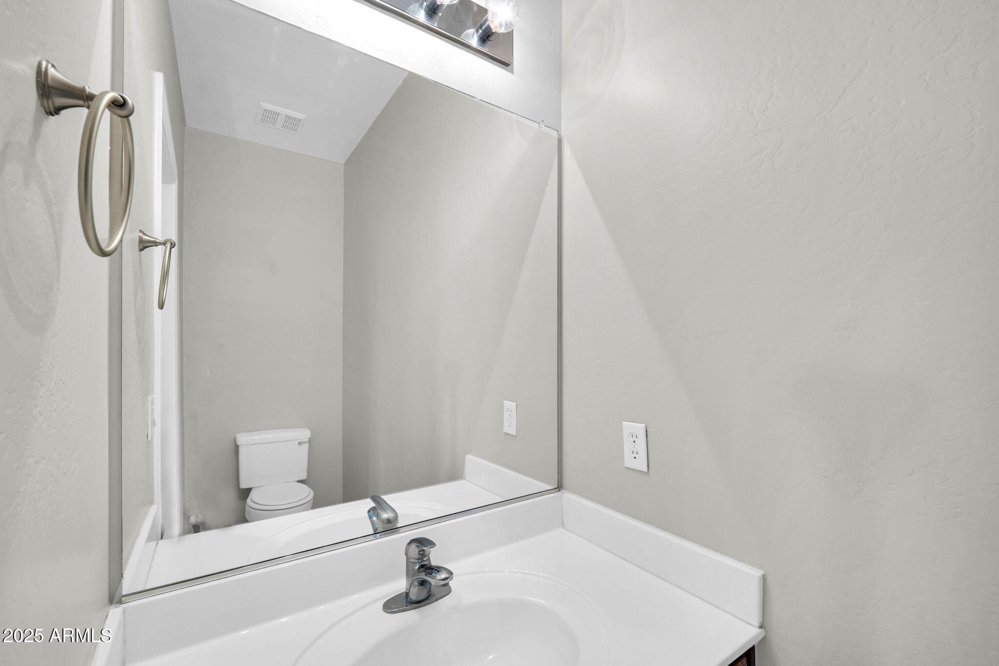 2605 West Darrel Road Phoenix, AZ 85041 - Photo 25 of 33 a bathroom with a sink and a mirror