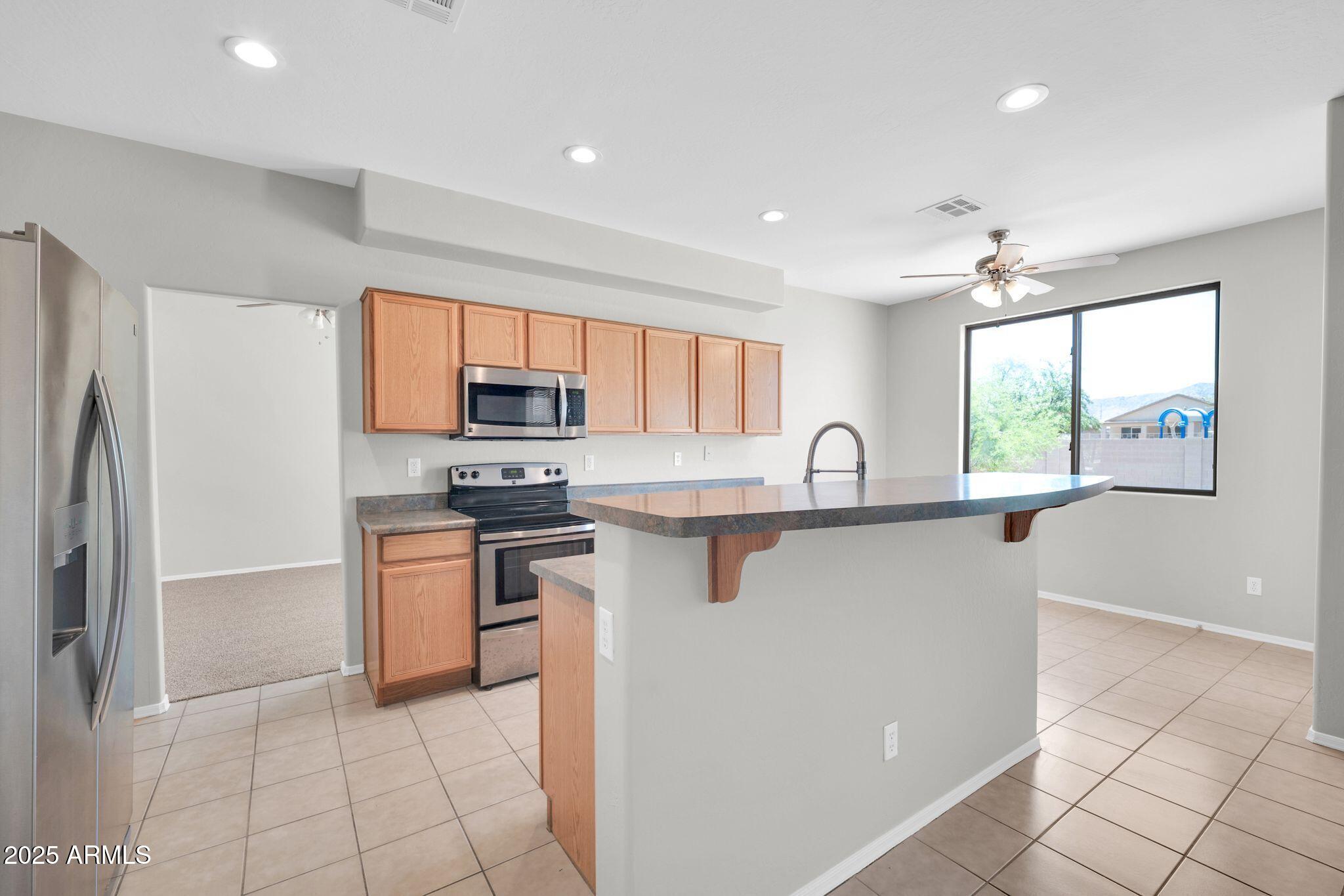 2605 West Darrel Road Phoenix, AZ 85041 - Photo 7 of 33 a kitchen with stainless steel appliances granite countertop a refrigerator and a sink