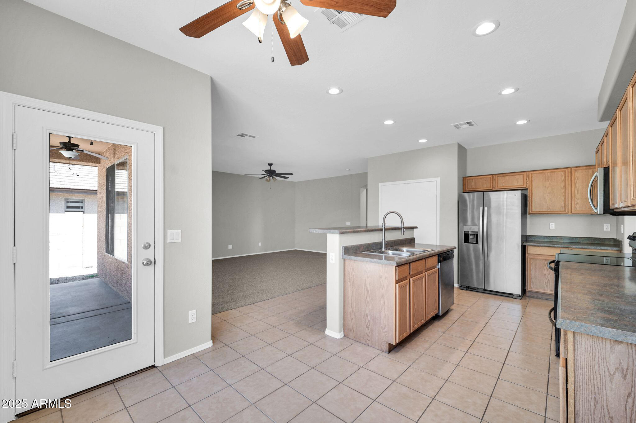 2605 West Darrel Road Phoenix, AZ 85041 - Photo 8 of 33 a kitchen with stainless steel appliances granite countertop a stove and a refrigerator