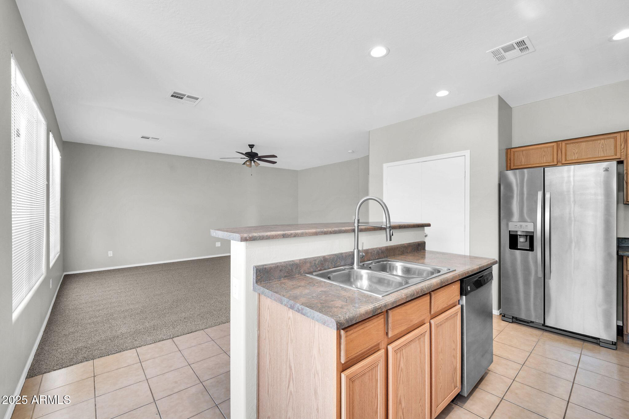 2605 West Darrel Road Phoenix, AZ 85041 - Photo 10 of 33 a kitchen with stainless steel appliances granite countertop a sink and a refrigerator