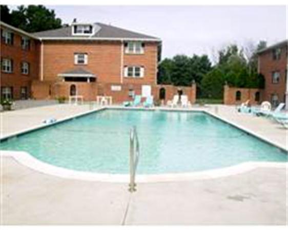 26 Leonard Road, Unit 26 Boxborough, MA 01719 - Photo 7 of 10 a view of a swimming pool with a table and chairs
