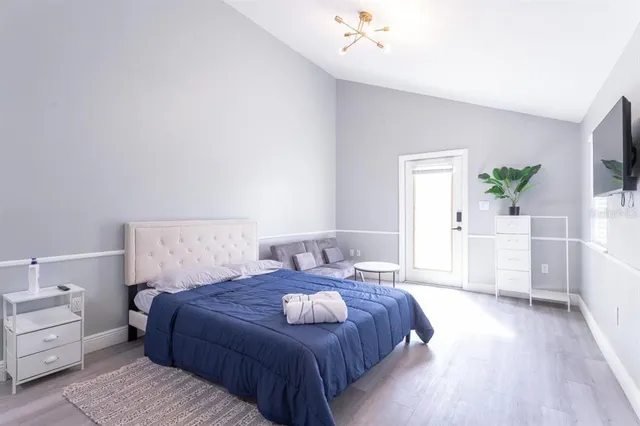 a bedroom with a bed and a couch