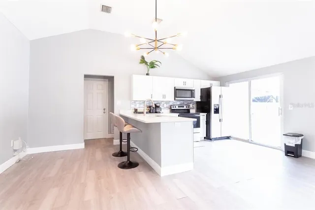 a kitchen with white cabinets and white appliances