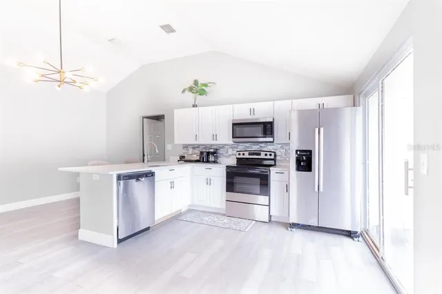 a kitchen with a sink appliances and cabinets