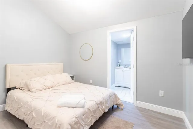 a bedroom with a bed and a shower